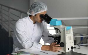 man looking through microscope