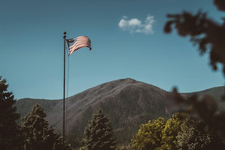 American flag with mountains in the background