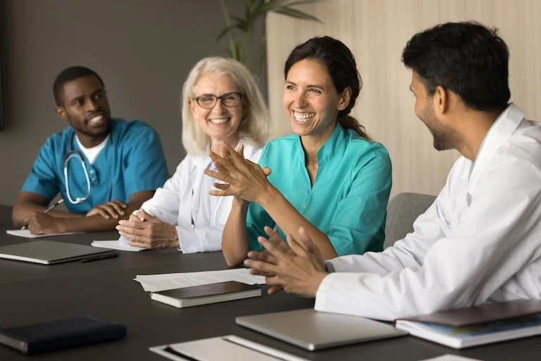 employees laughing at table